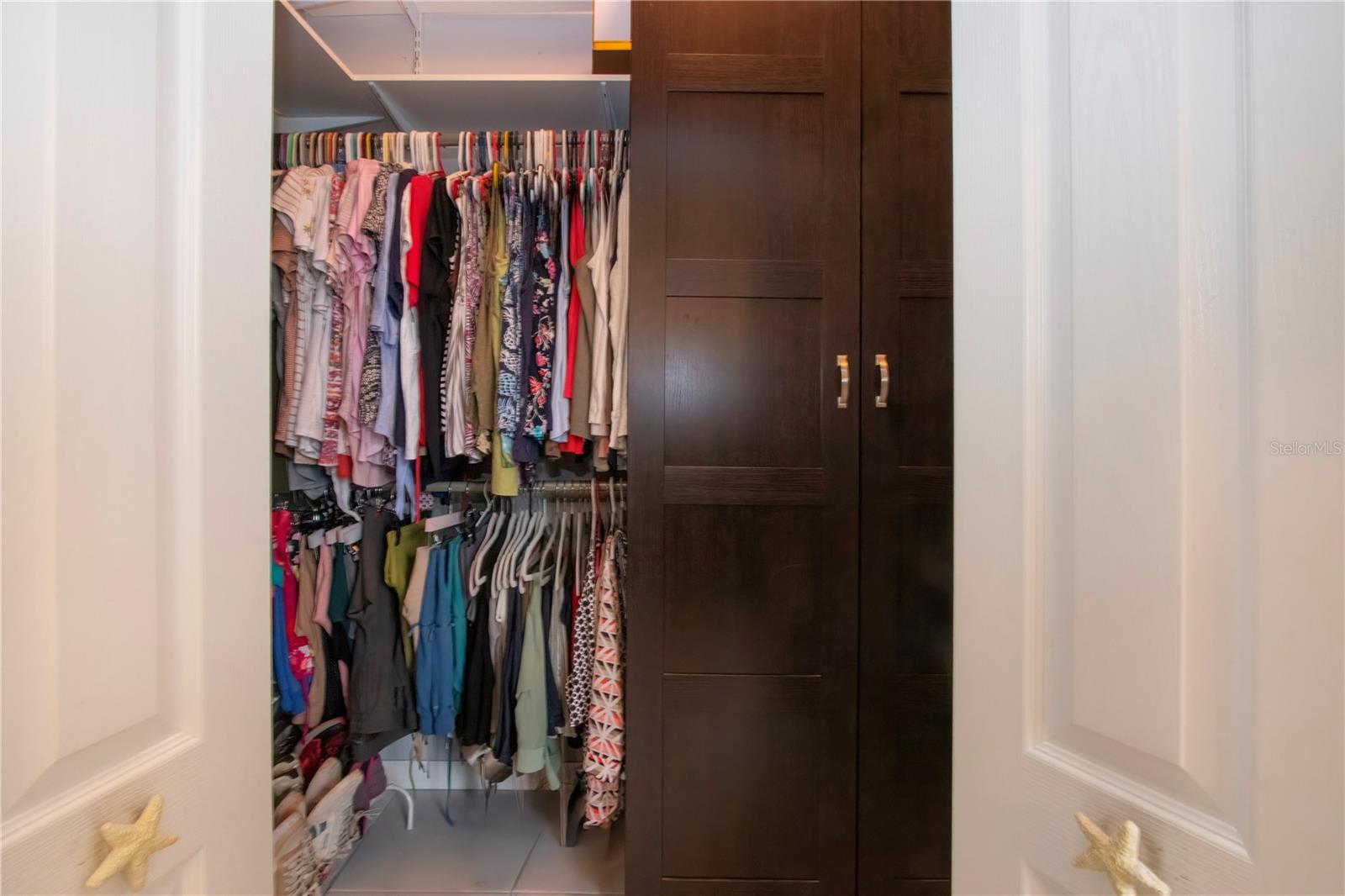 Large walk in closet with built in storage