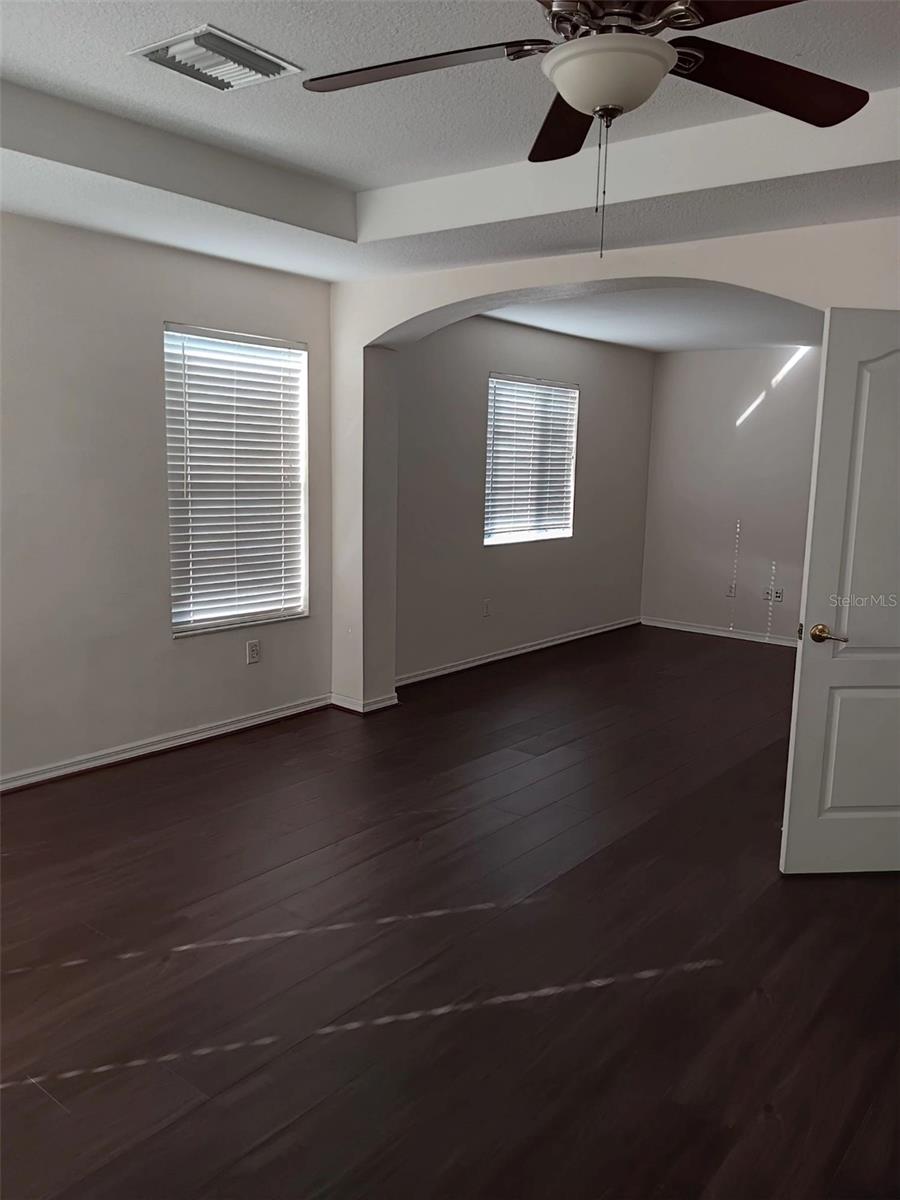 master bedroom with tray ceiling