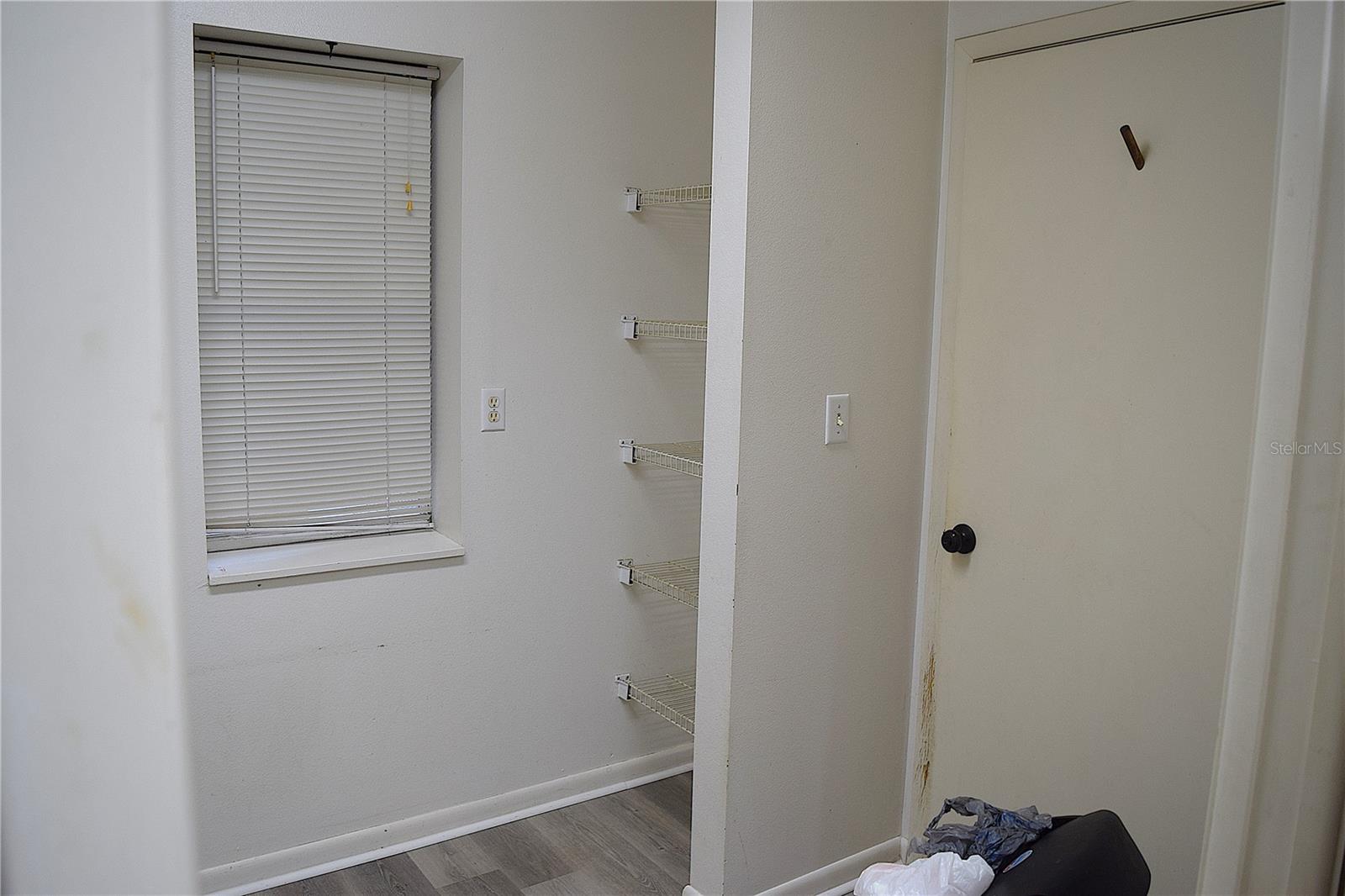 Utility Room with storage and door to 1 car garage