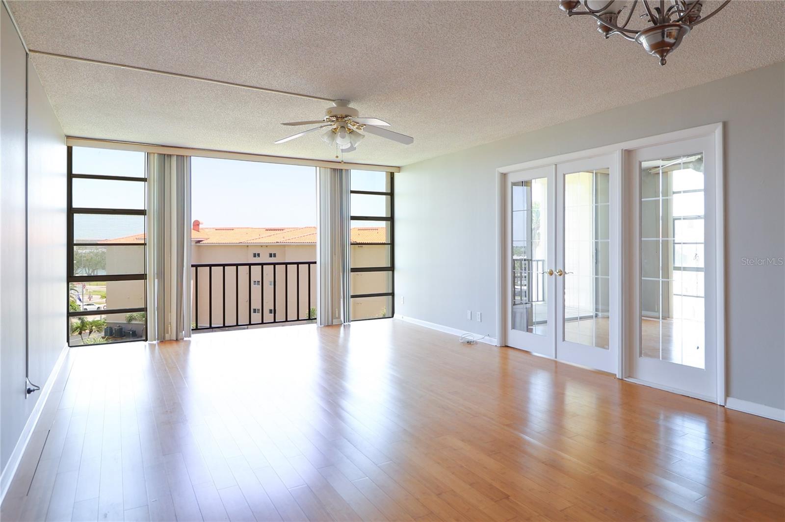 living room with view of guest room/bonus room