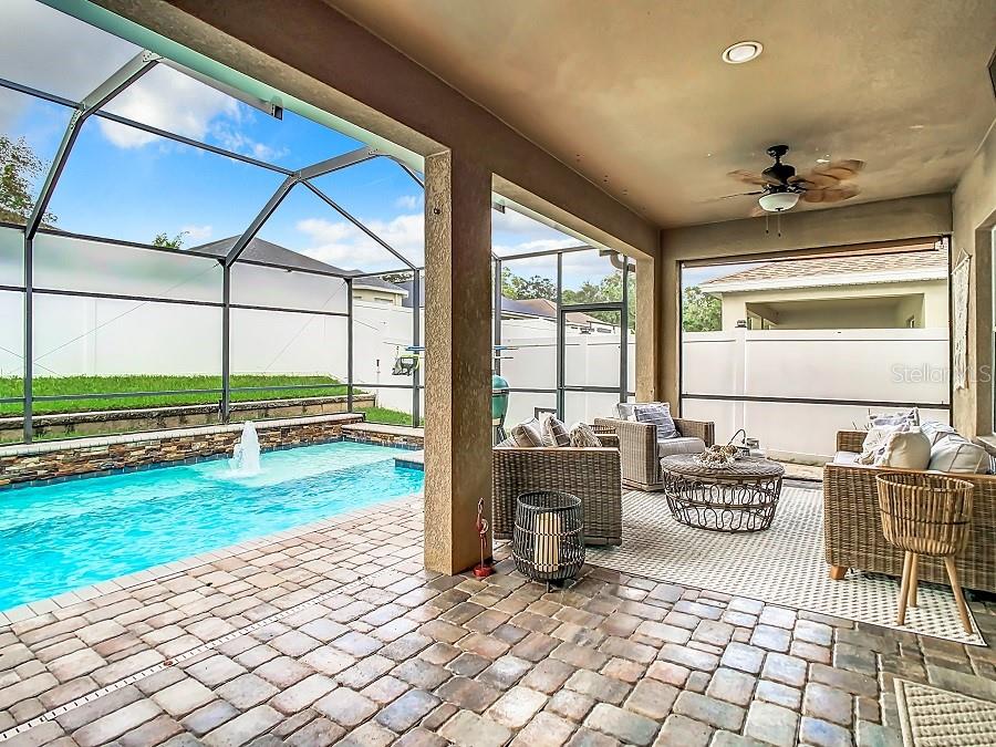 Brick paver pool deck with covered area for grilling on those rainy days