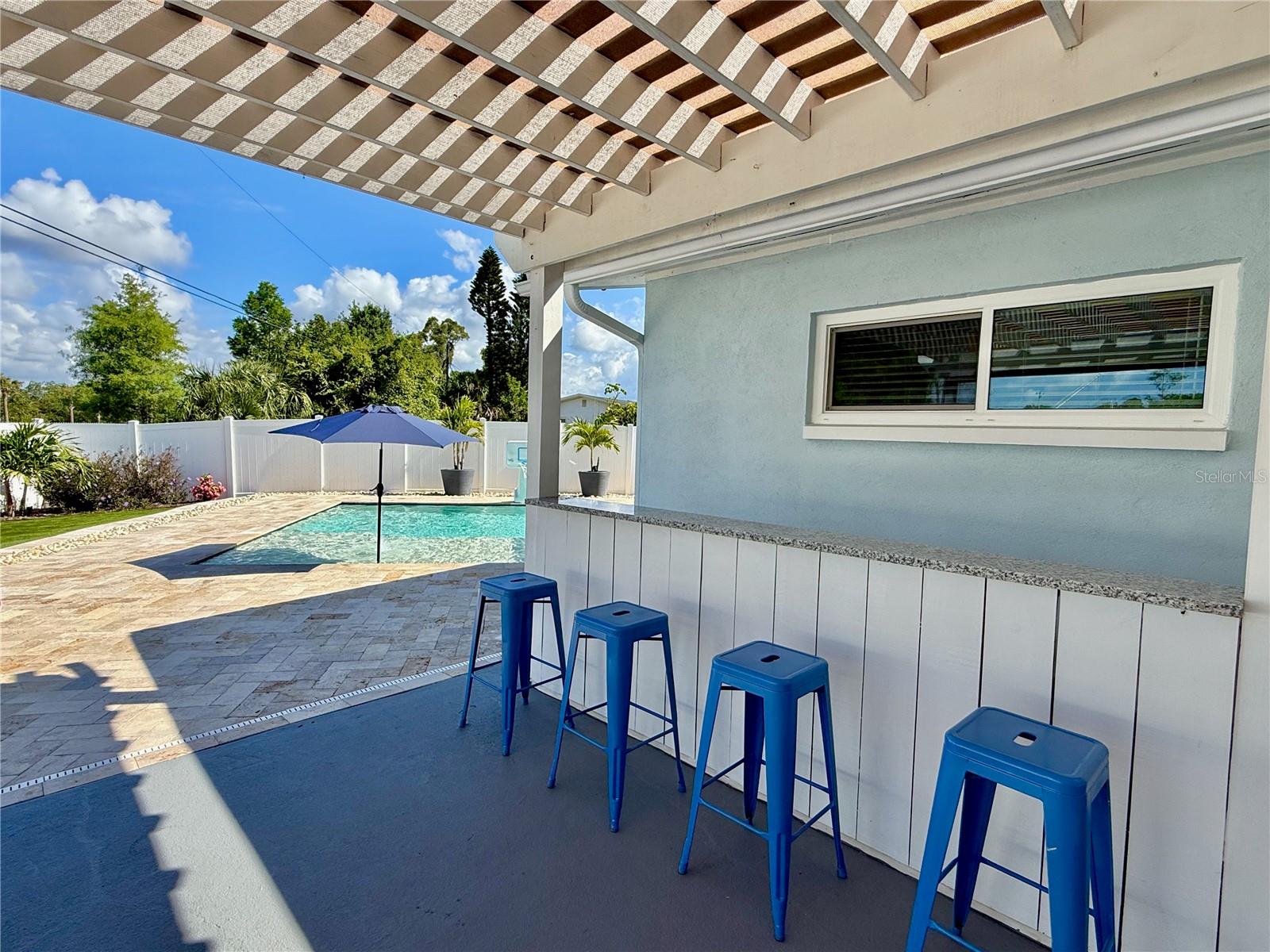 Granite outdoor bar with seating for four.