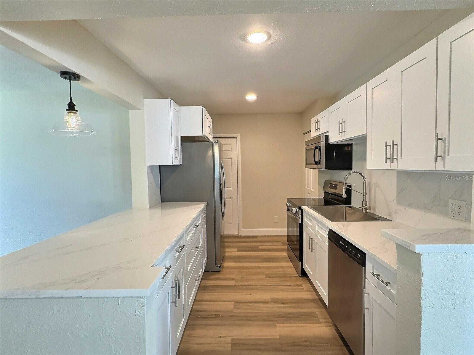 Quartz countertops with seamless matching quartz backsplash