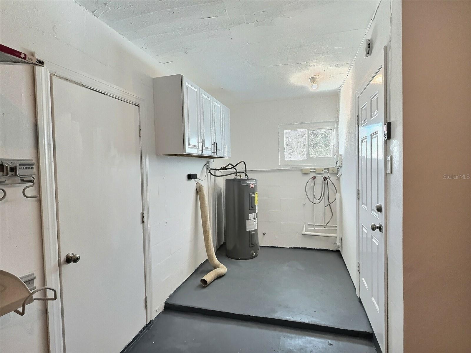 Laundry room located in garage.
