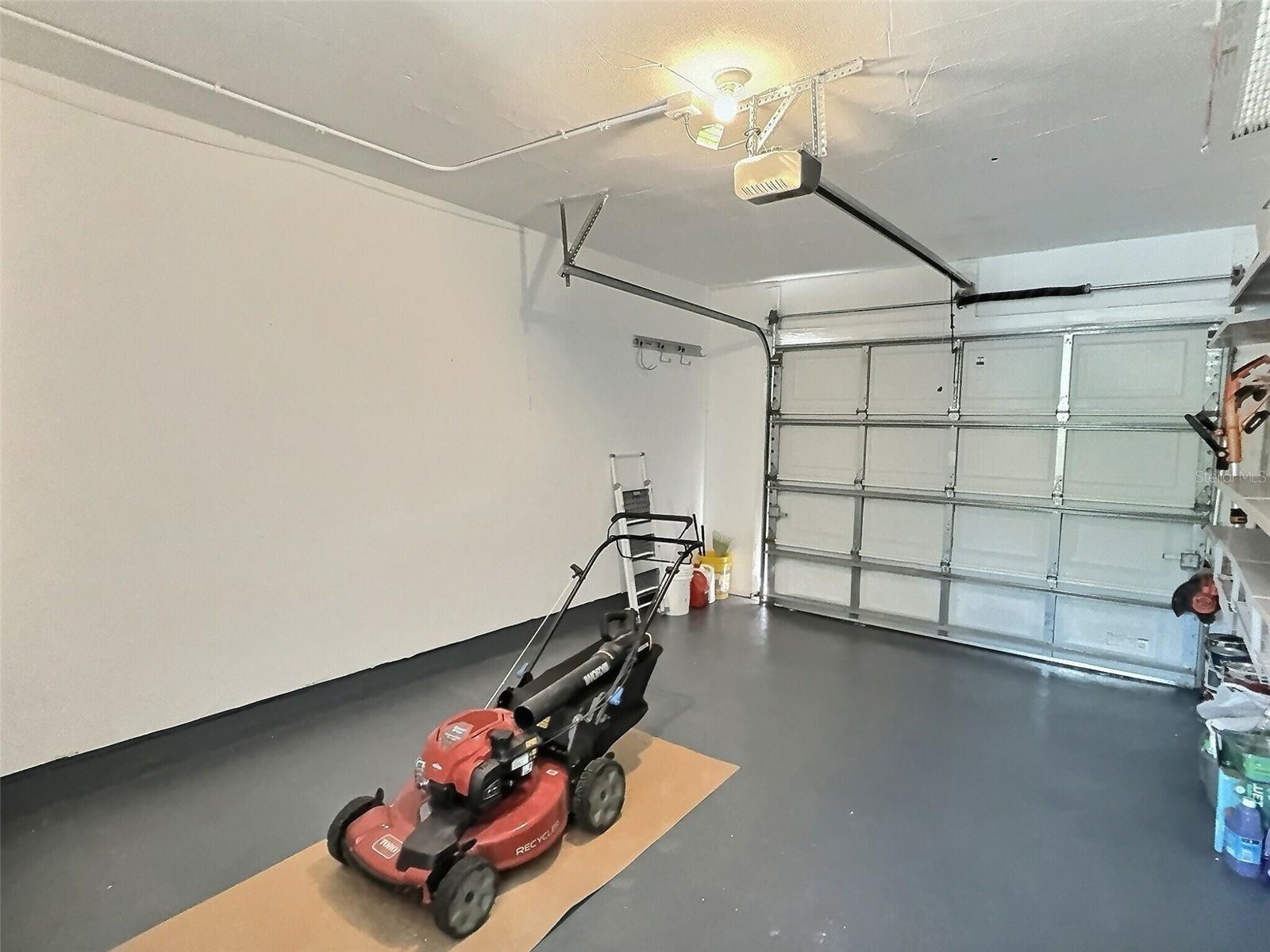 Single car garage with storage racks.