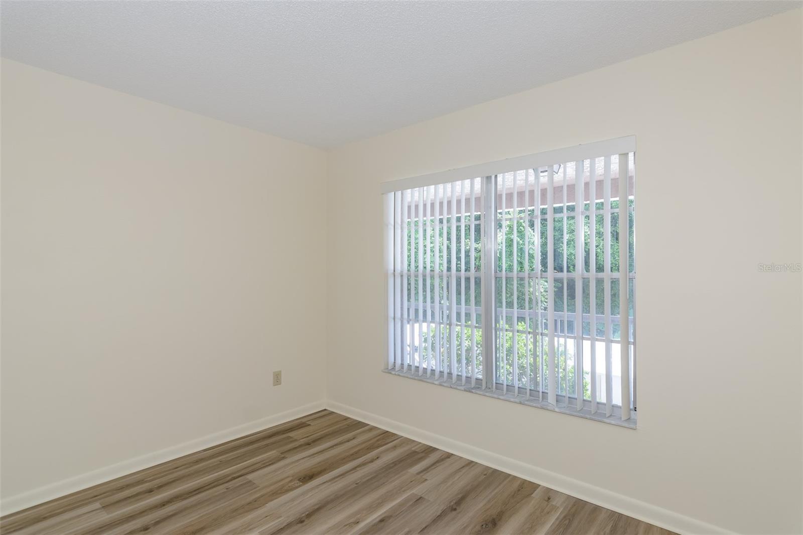 Guest bedroom window provides natural light.