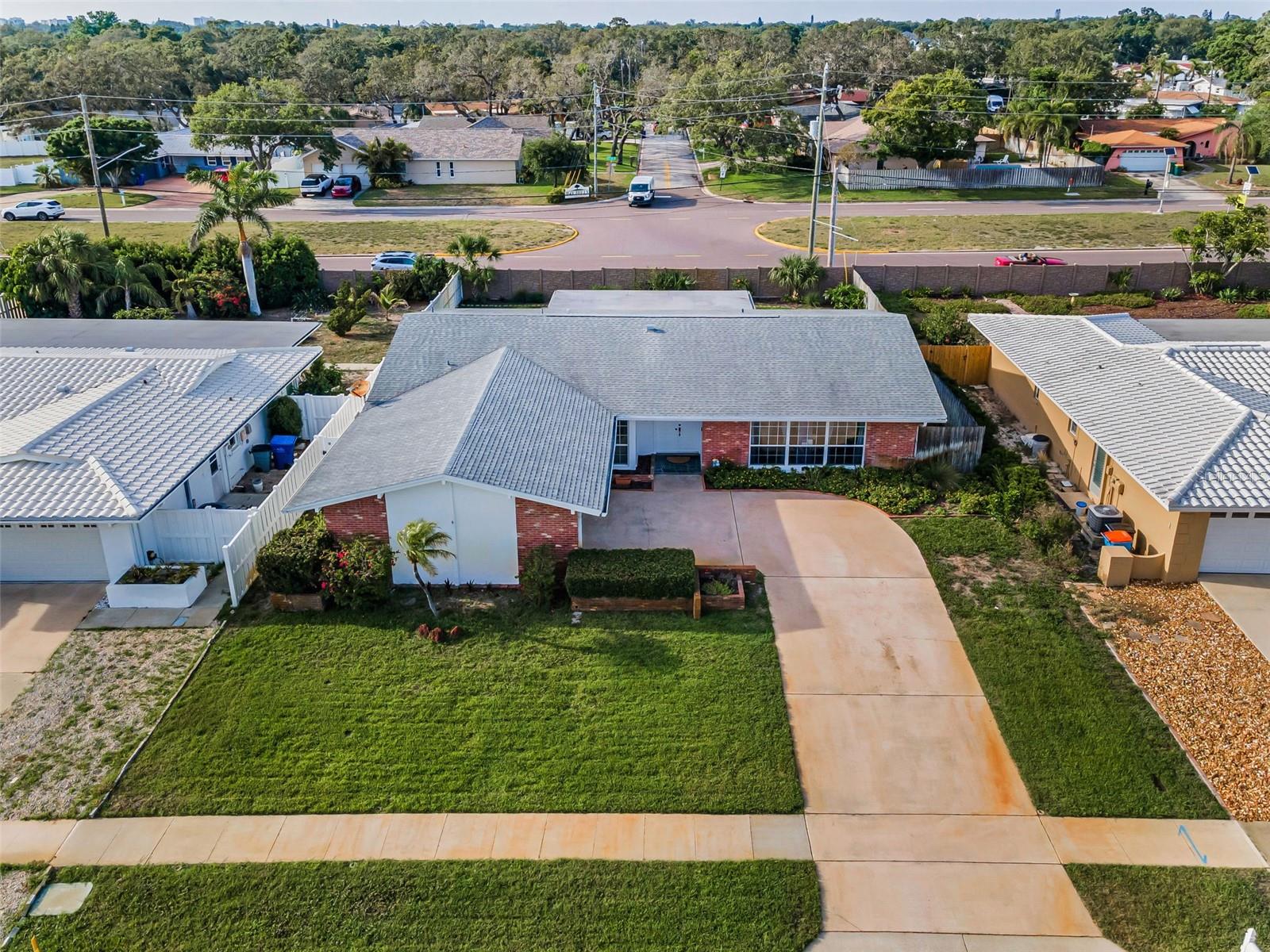 ... Nice Shot of Exterior Front.. Plenty of Room For a RV ... Especially if You Move Grass line to Right of Driveway or Park on The Grass on East Side ..