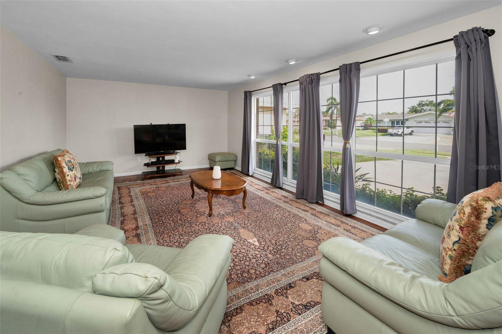 .. Living Room 23 x 13.6 With a Bank of Windows Overlooking the Front Yard.