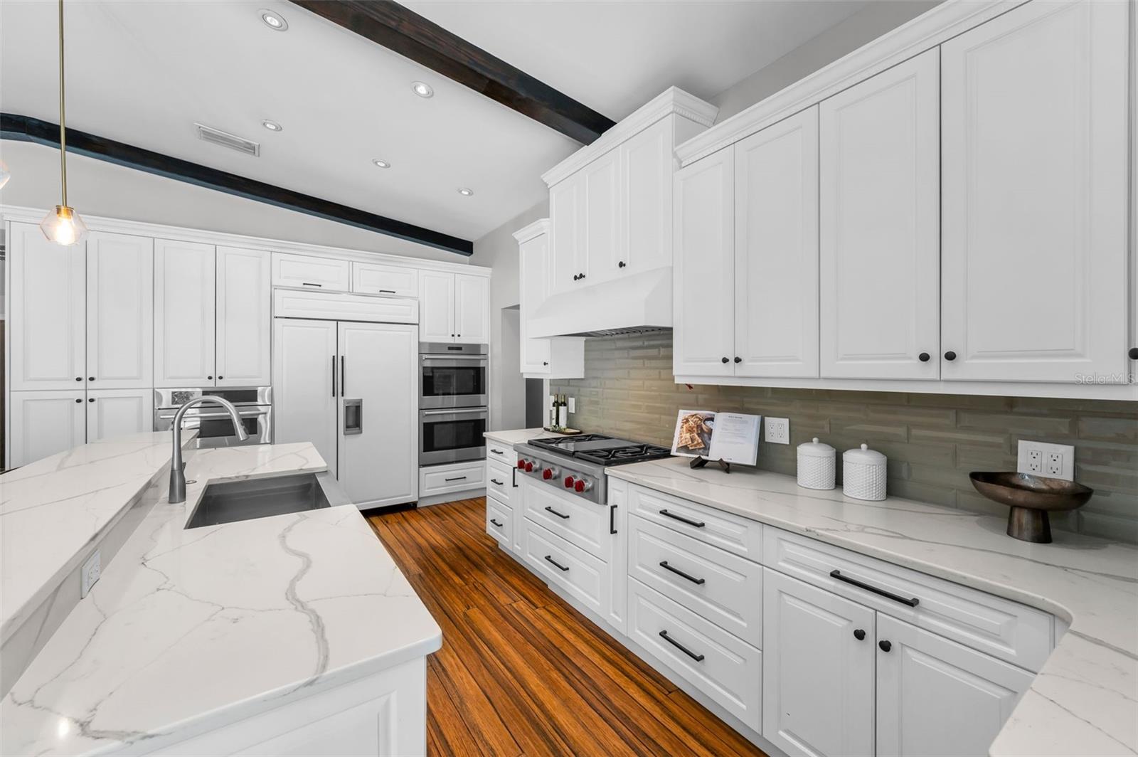 5 Burner Wolf gas stove, double Wolf ovens, and a Sub-Zero refrigerator making preparing meals a dream.