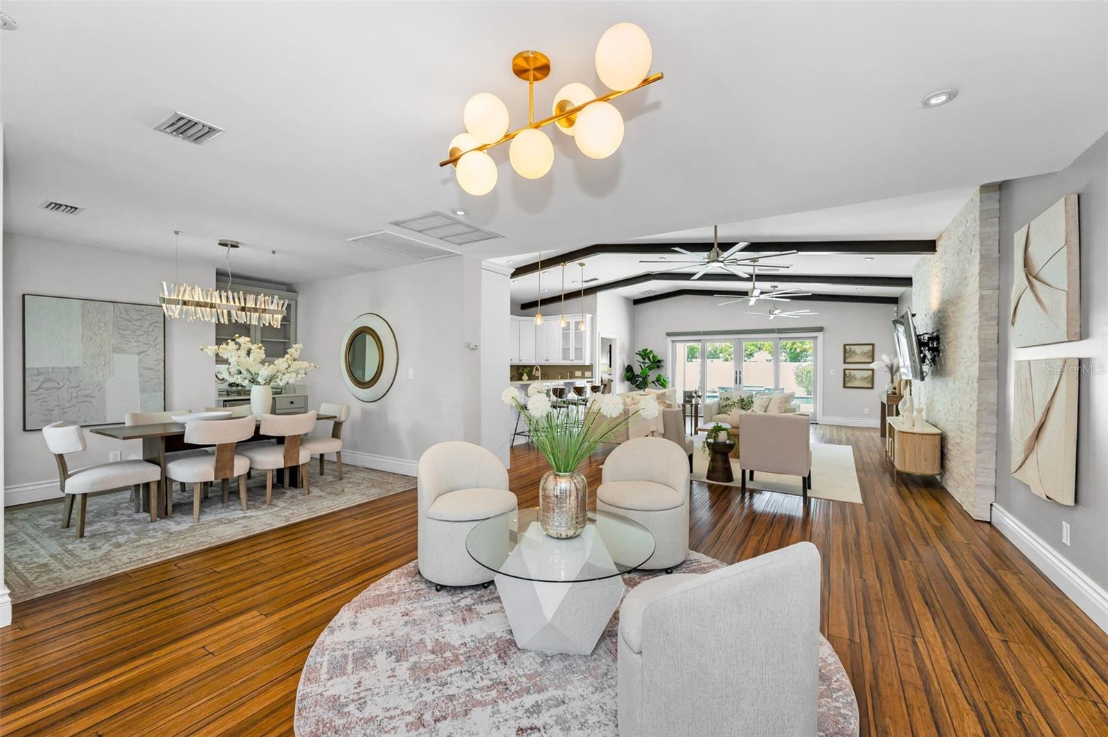 Gorgeous wood beams and stylish light fixtures add perfect detail to this bright and spacious open floorplan.