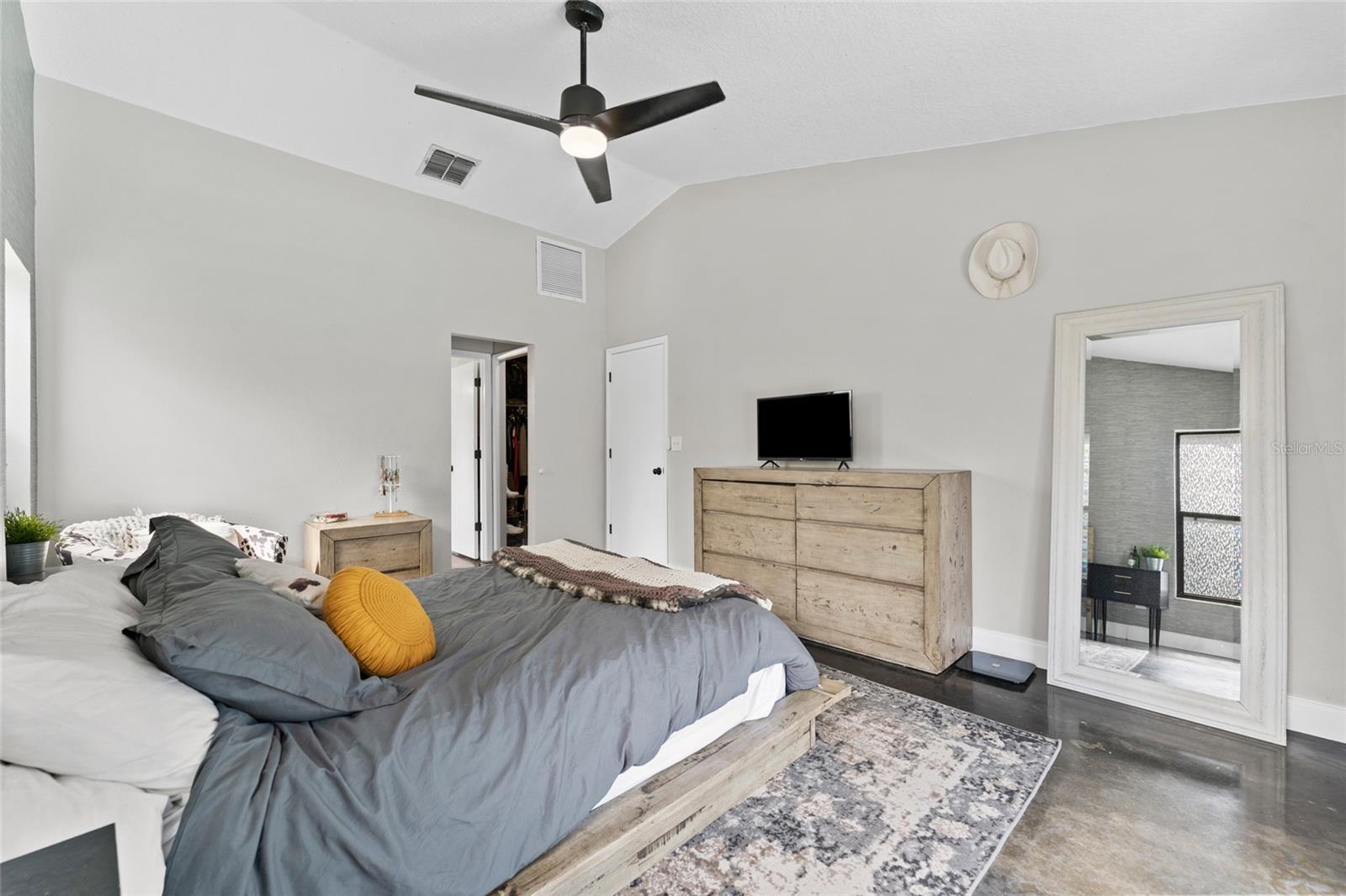 Stylish and serene, this primary bedroom includes easy access to the en-suite bath and walk-in closet—comfort and function combined.