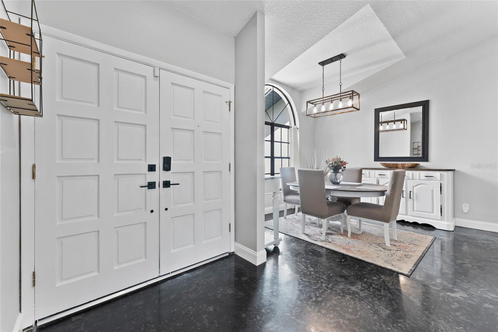 Welcome home to 8638 Chadwick Drive! This striking entryway sets the tone with bold double doors, modern fixtures, and freshly painted interiors—offering a grand entrance that wows guests and invites comfort.