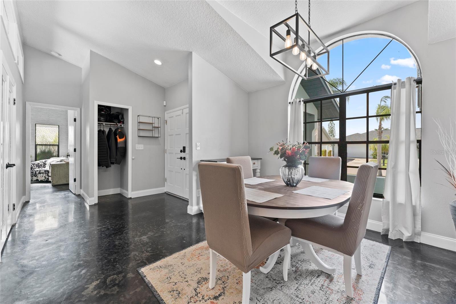 Enjoy natural light and views from the dramatic arched window in the dining room. Perfect for hosting, this space blends traditional charm with modern upgrades at this Tampa gem.