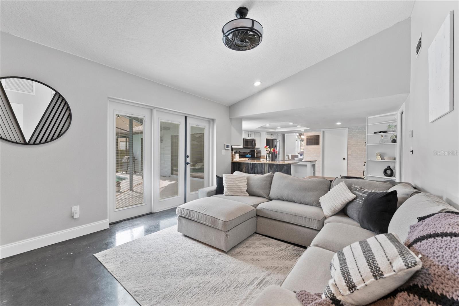Enjoy indoor-outdoor living with French doors that open to the screened lanai and pool area. This light-filled space is the perfect retreat in your Tampa sanctuary.