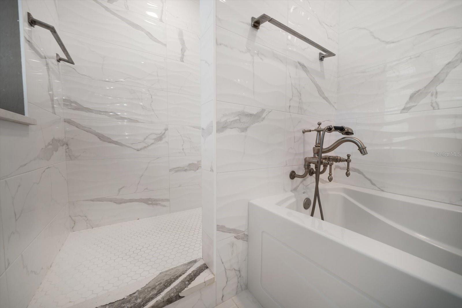 Walk in shower and tub in Primary bath room area.
