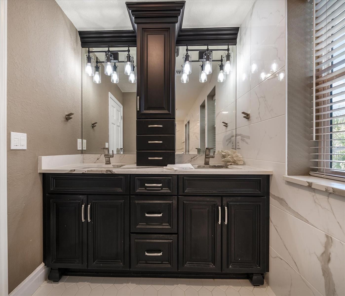 Dual vanities and additional towers for storage in Primary bath area.