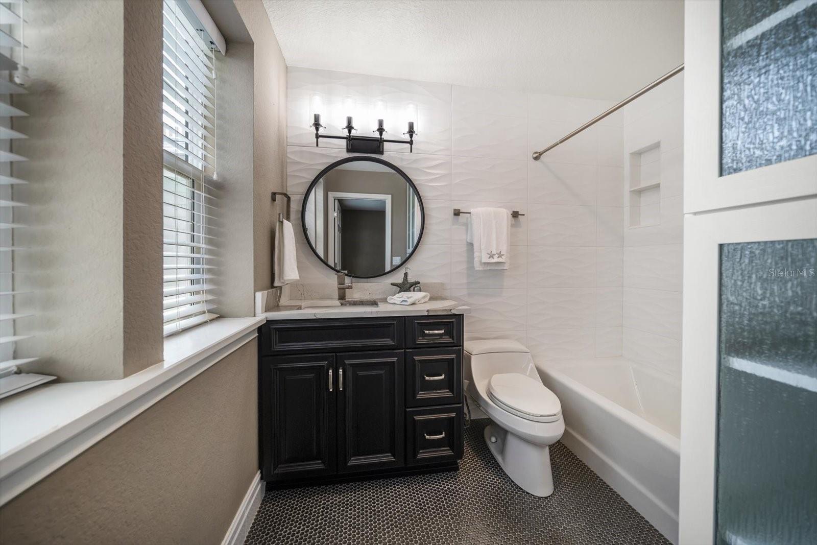 Second bedroom ensuite bathroom. Bath and storage-gorgeous tile work.