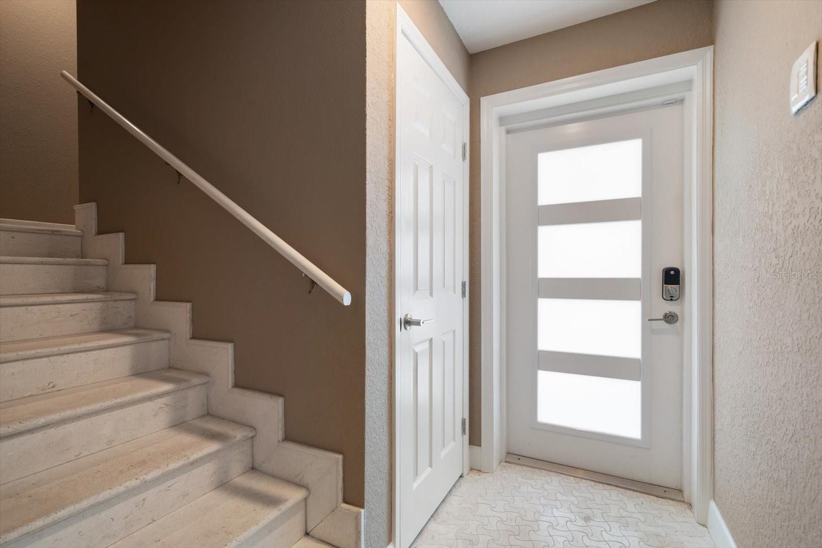 Impressive entry with timeless fossil stone applications-attractive new entry door provides natural light.