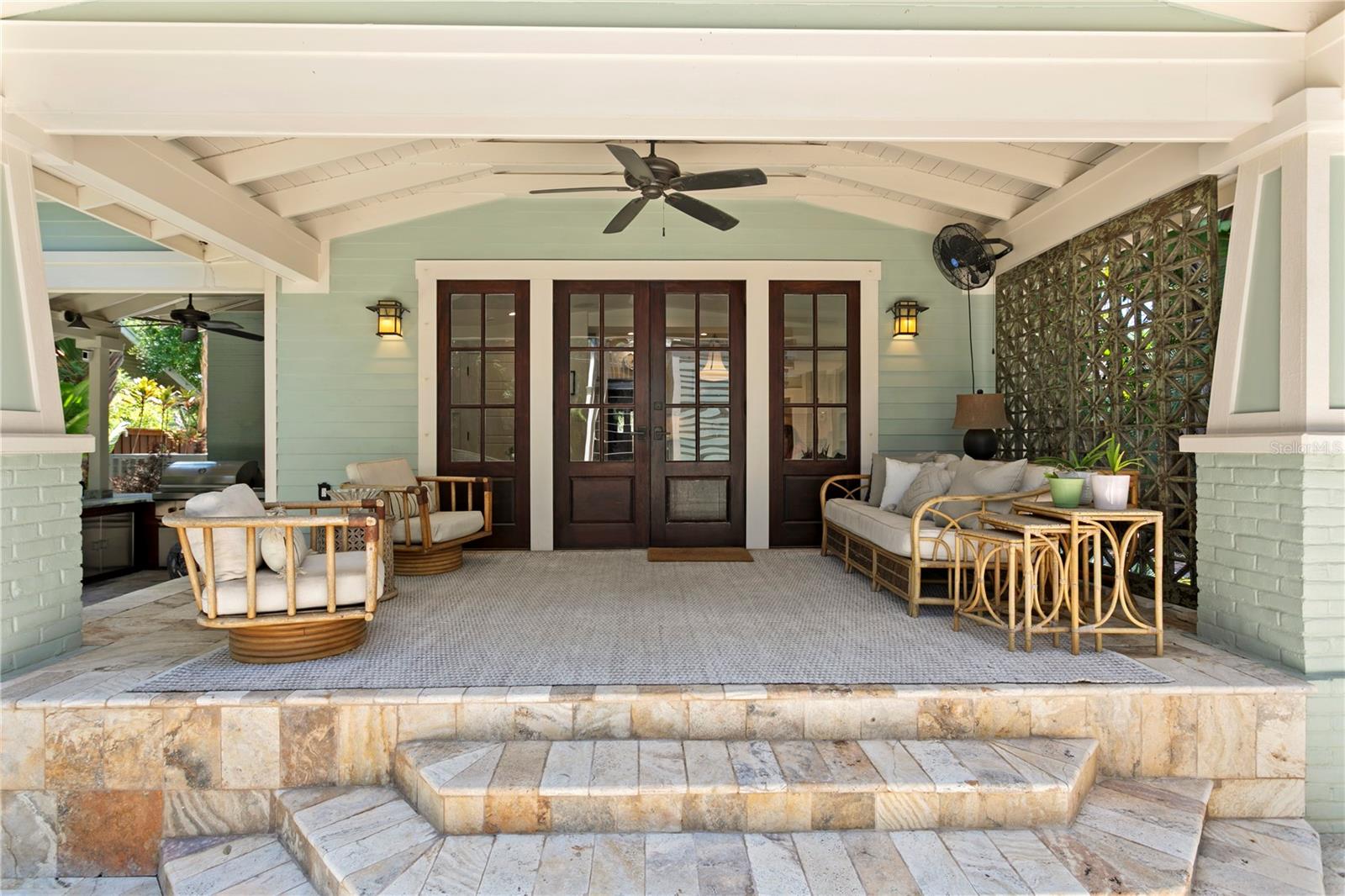 Unwind in your private tropical backyard oasis with pool, outdoor kitchen, and additional covered porch—ideal for seamless indoor-outdoor living and entertaining