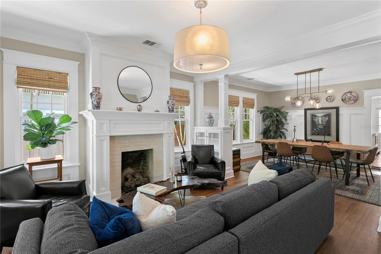 As you step inside, you're greeted by rich hardwood floors, a cozy gas fireplace, beams, and timeless historic details that elevate the charm of the front living and dining room.