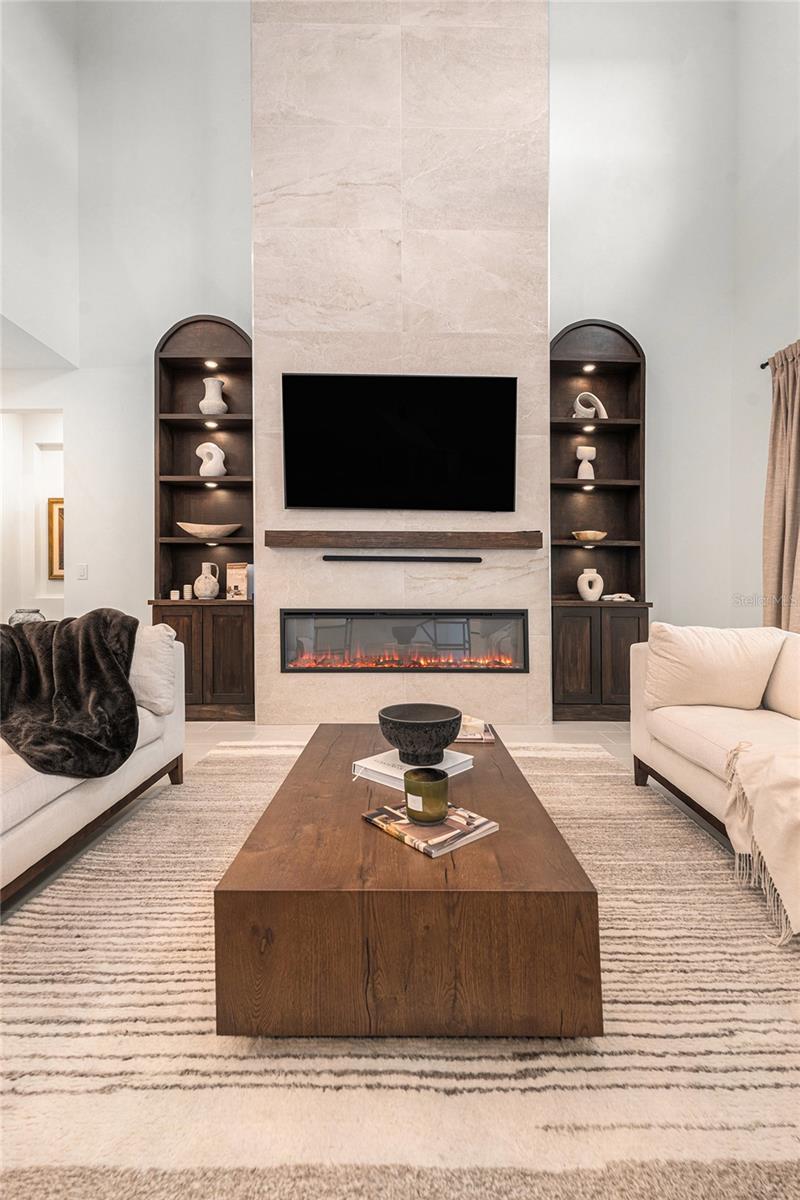 Custom wall with mantle, fireplace and side built-ins.