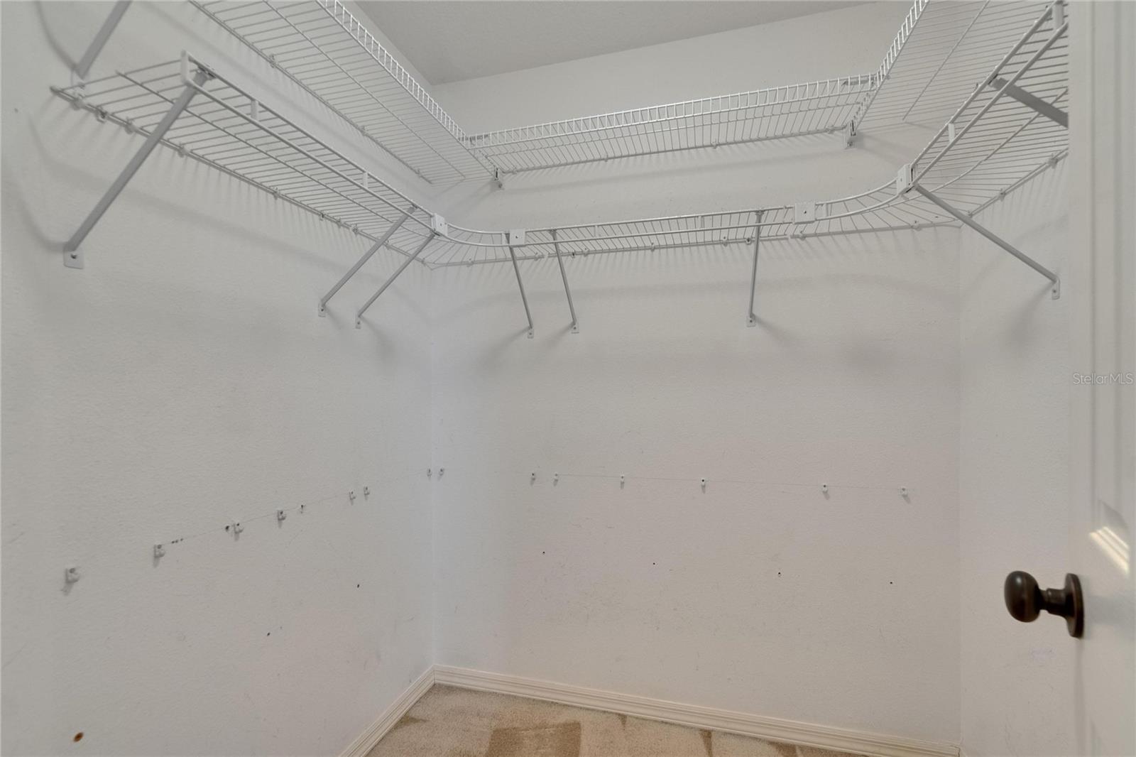 Walk in closet in primary bedroom.