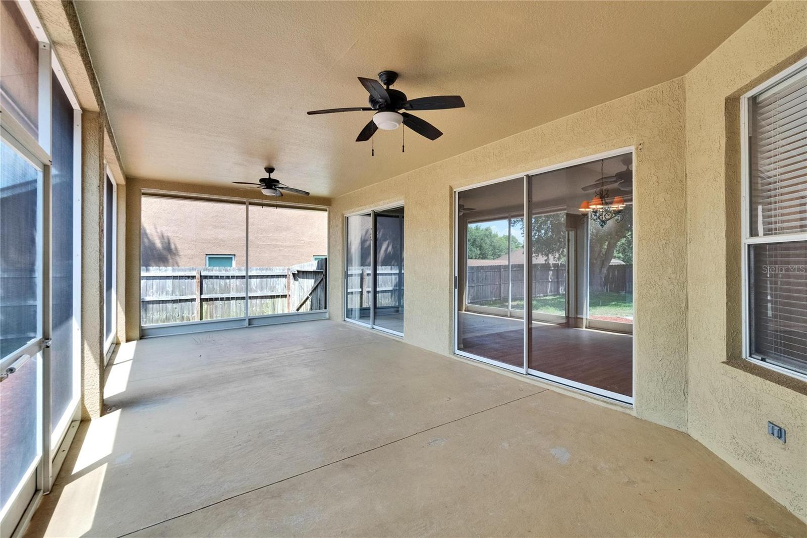 Lanai. Primary Bedroom Sliders to far Left and then Living Room Sliders