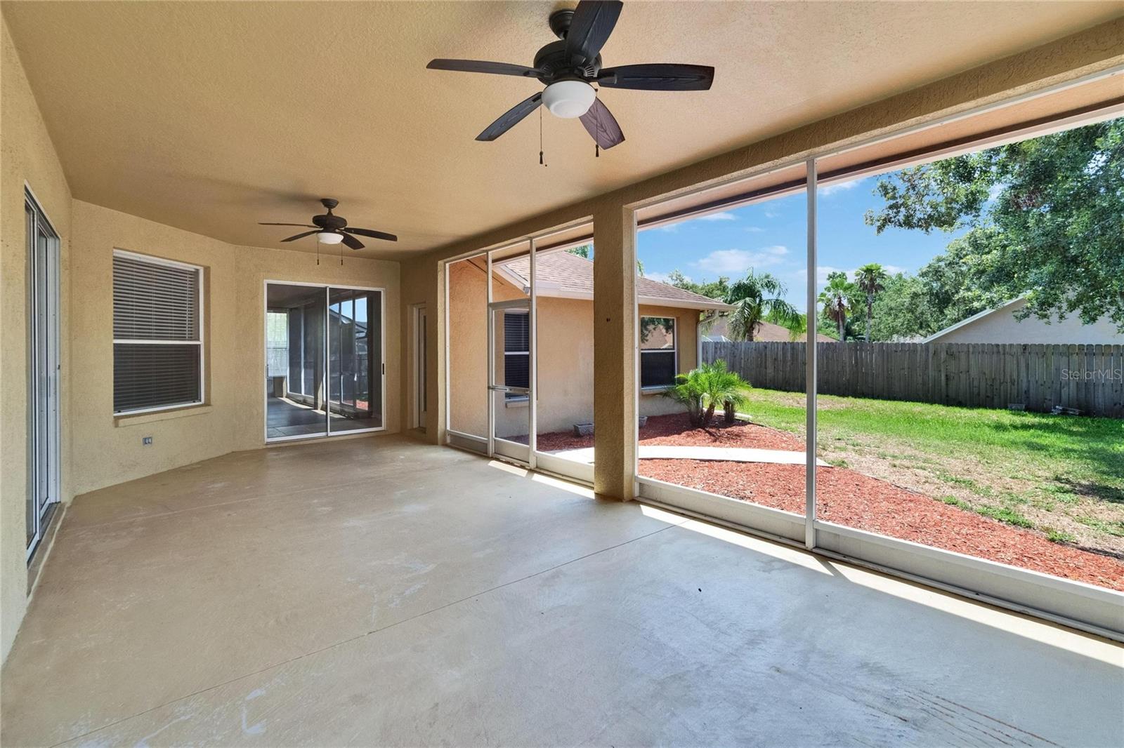 Lanai from Primary Bedroom Sliders Looking to backyard and Family Room Sliders to Far Side