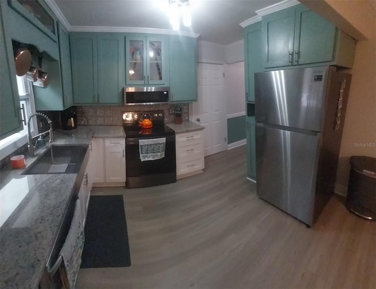 Kitchen has beautiful granite countertops and stainless steel appliances.