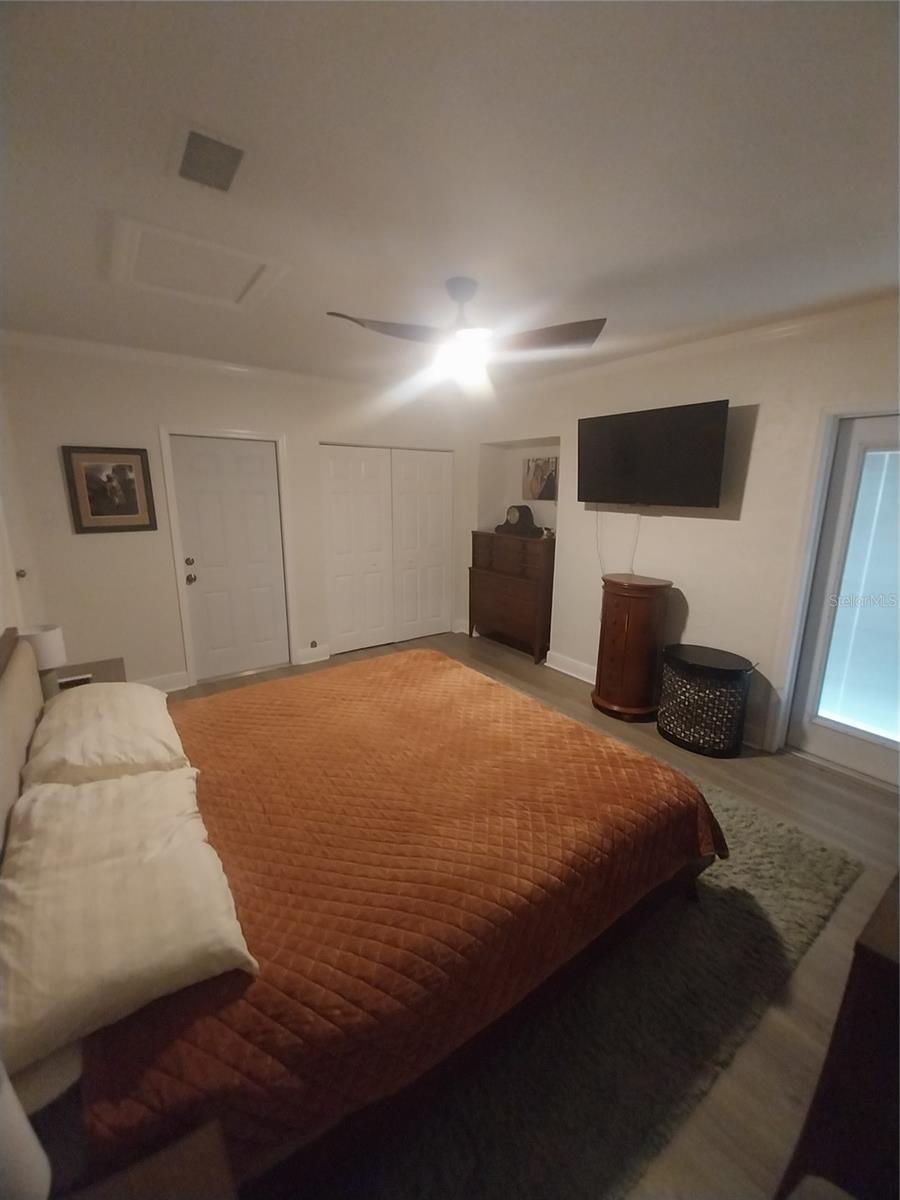 Primary bedroom also has access to the laundry and storage room, and access to the side and rear of the house.
