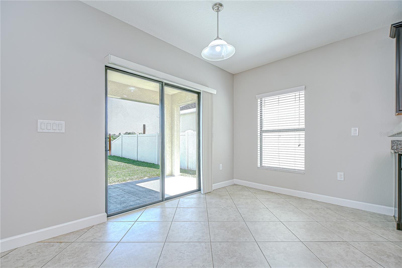 The sunlit dinette overlooks the tranquil pond and leads directly out to the fully fenced backyard!