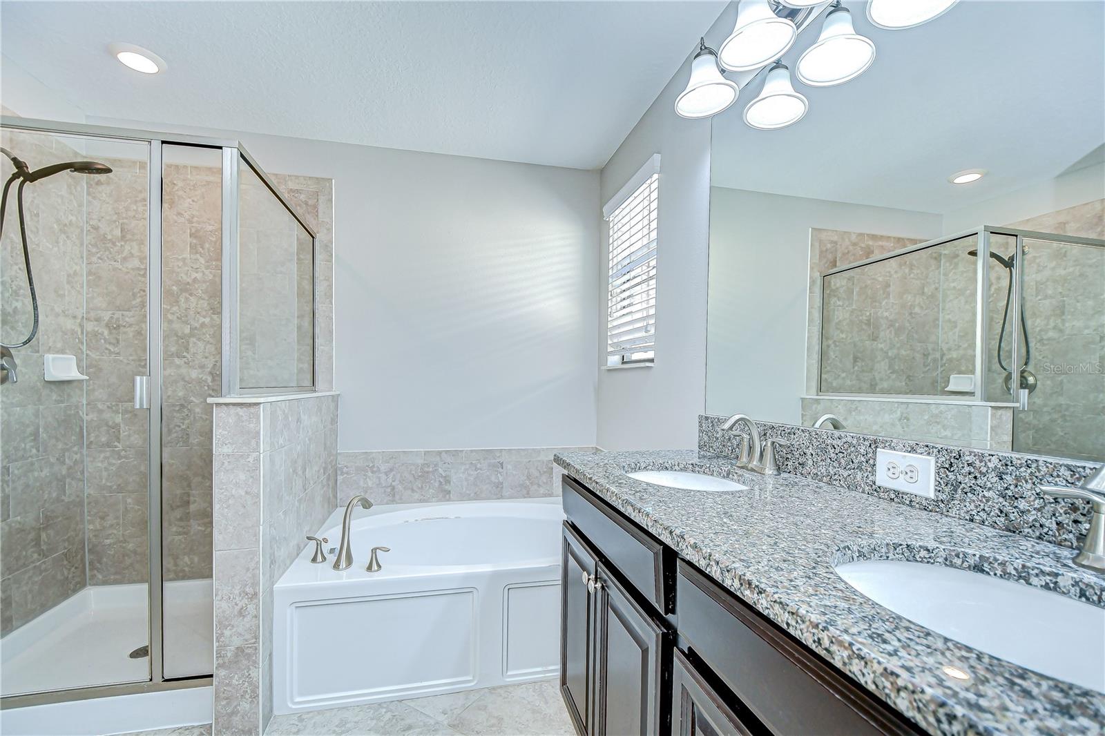 Primary bathroom offers dual sinks, walk-in shower, and separate tub!