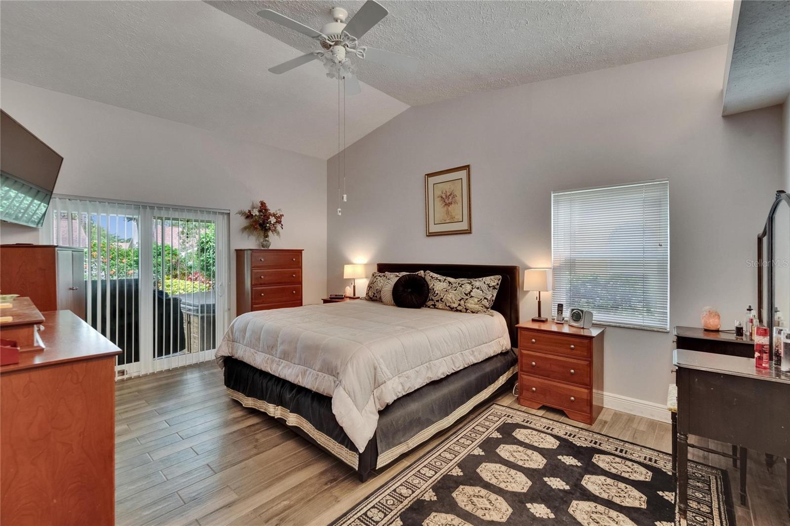 Primary bedroom with vaulted ceilings.