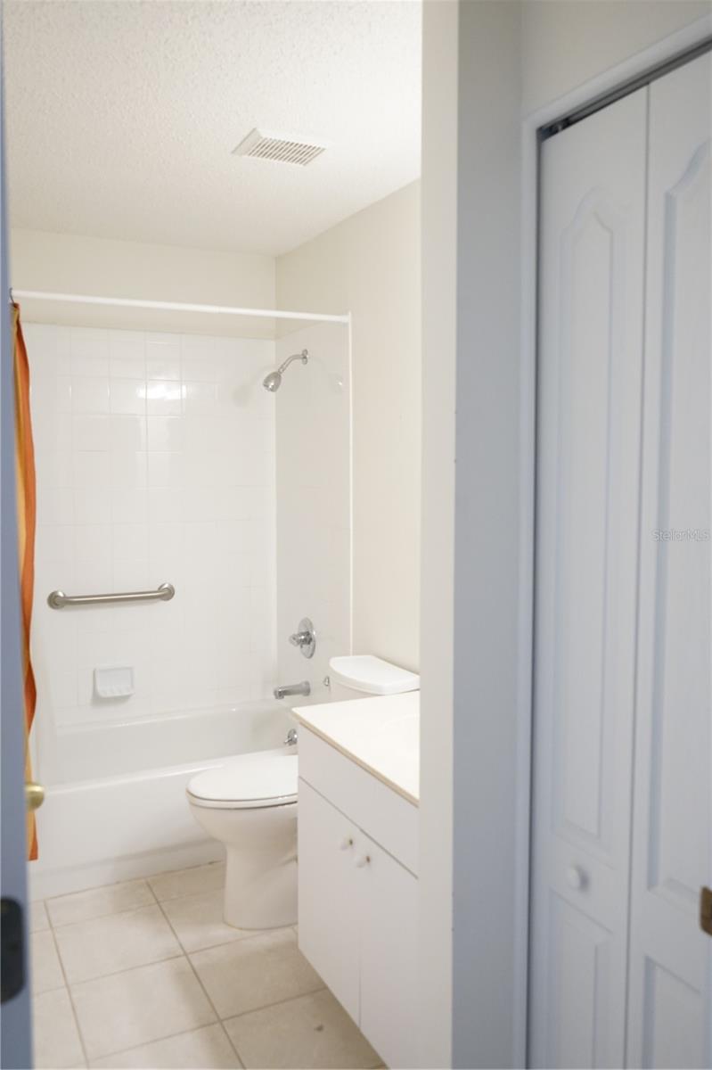 guest bathroom has a linen closet