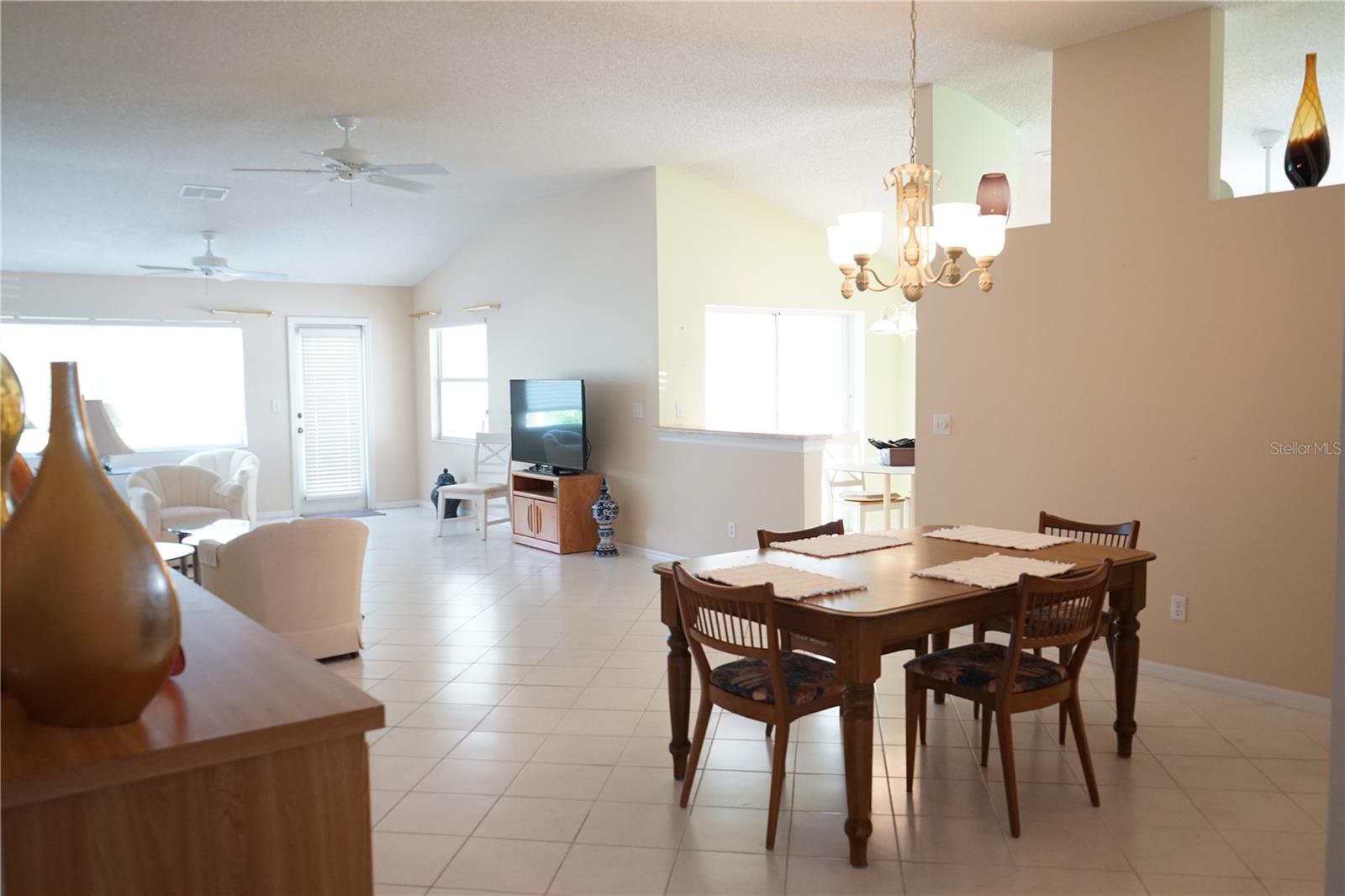 dining and living room space has high ceilings
