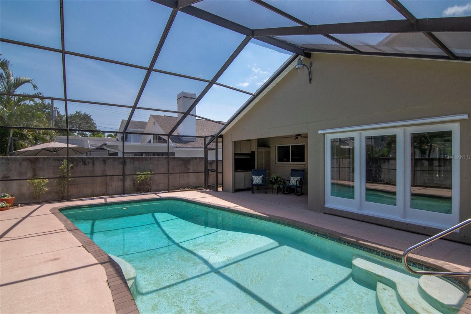 Love the Florida lifestyle withe a screened, heated pool and shaded spot to relax. Three family room windows bring the outside in.