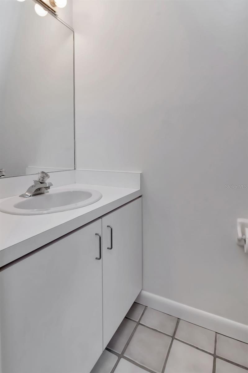 half bath tucked under stairs to 2nd floor