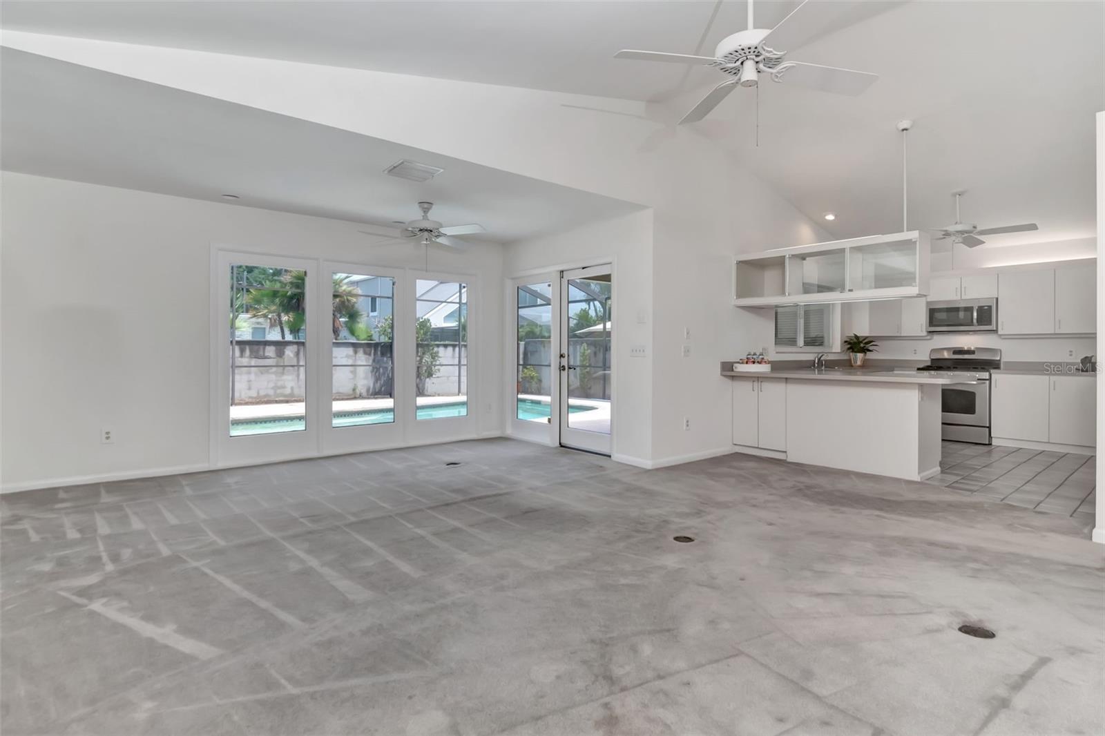 Family room and kitchen open into each other and overlook the pool