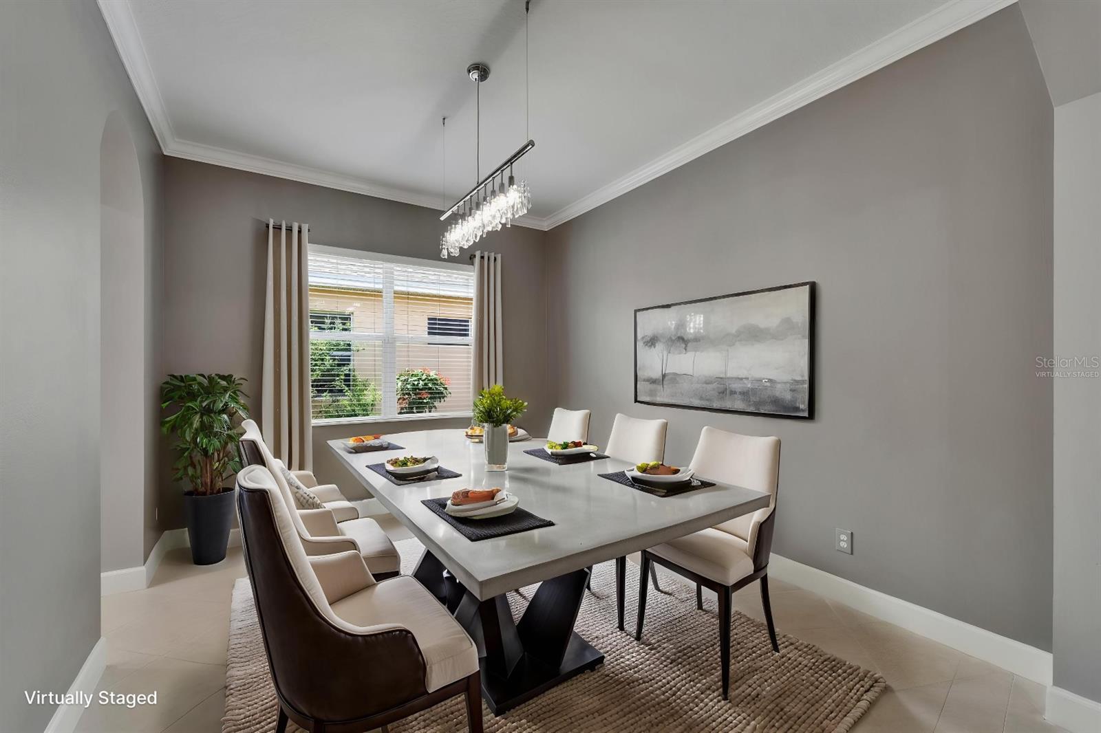 Formal dining room with crystal designer chandelier - Virtually Staged