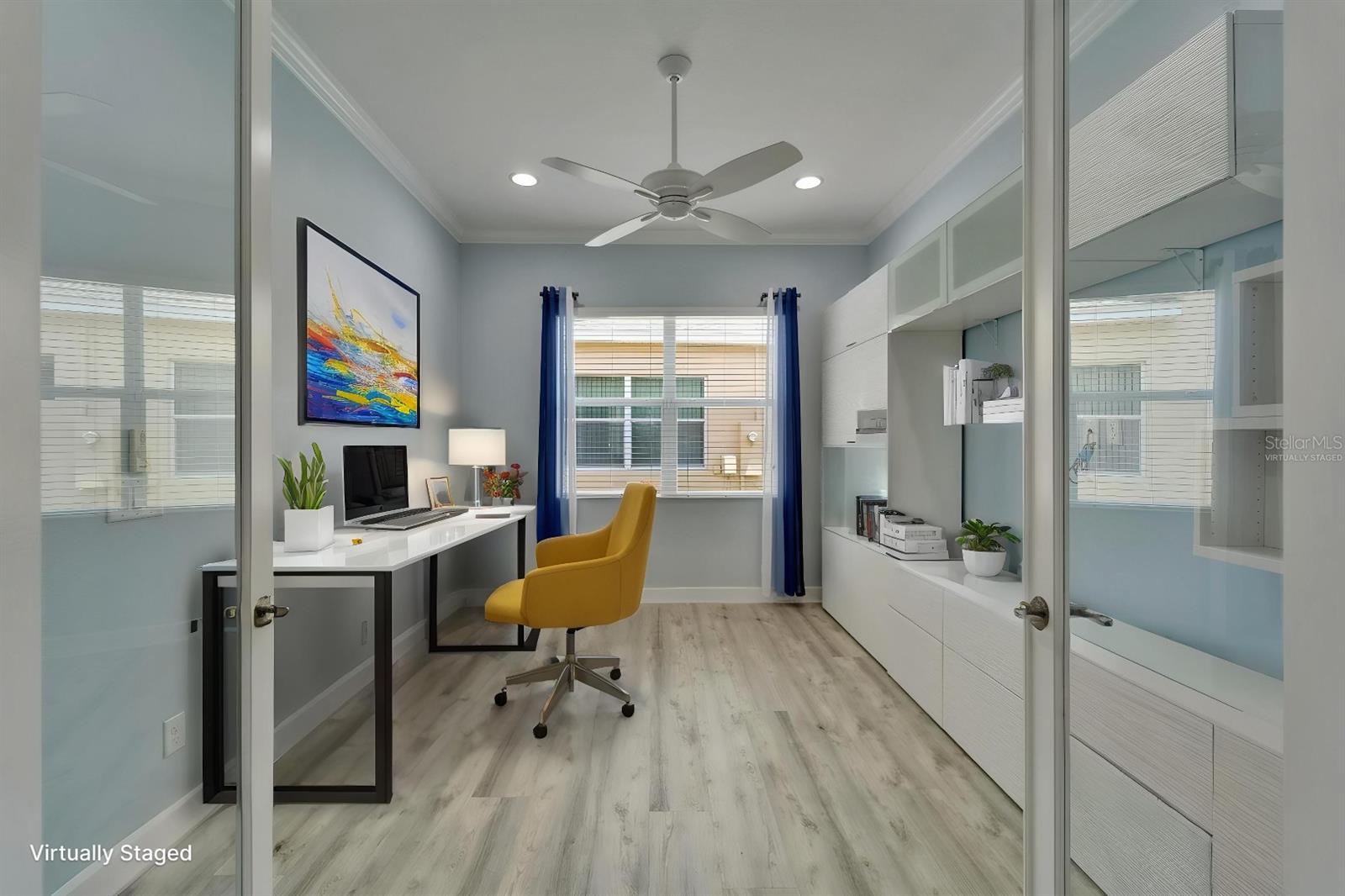 Den_Office with 8 ft French glass doors, custom storage adjacent to the dining room - Virtually Staged