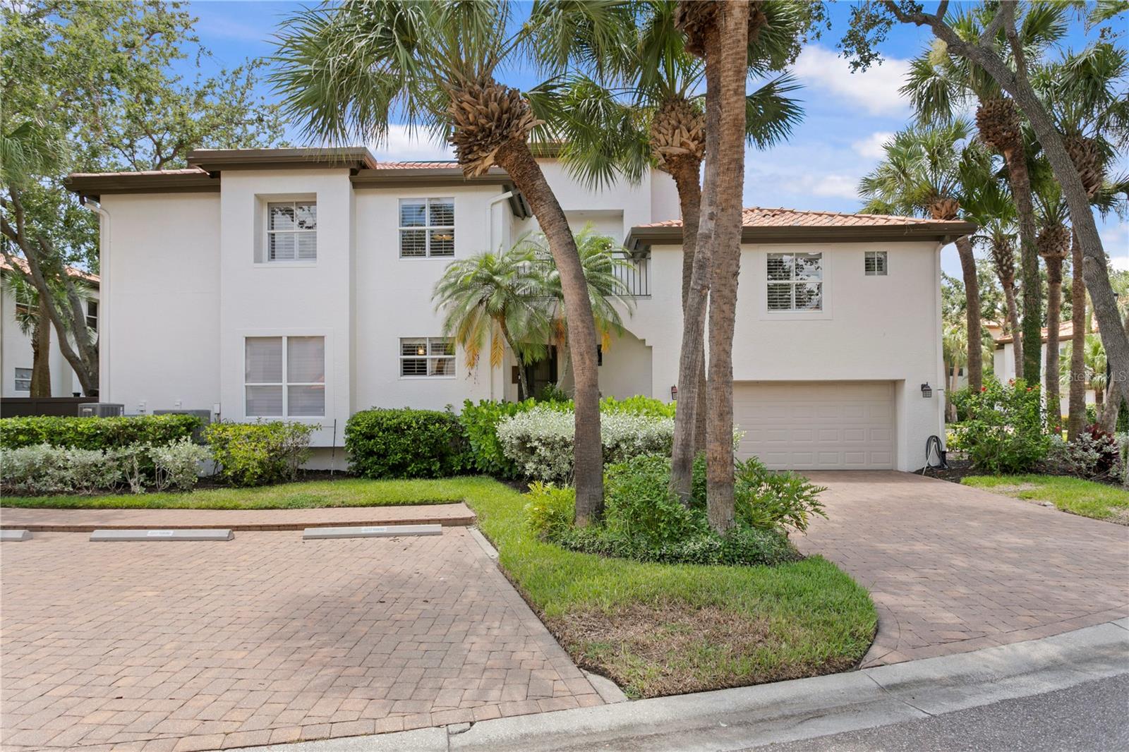 Rarely available in Harbour Homes, this end-unit townhome is filled with natural light thanks to windows and sliding glass doors on three sides!