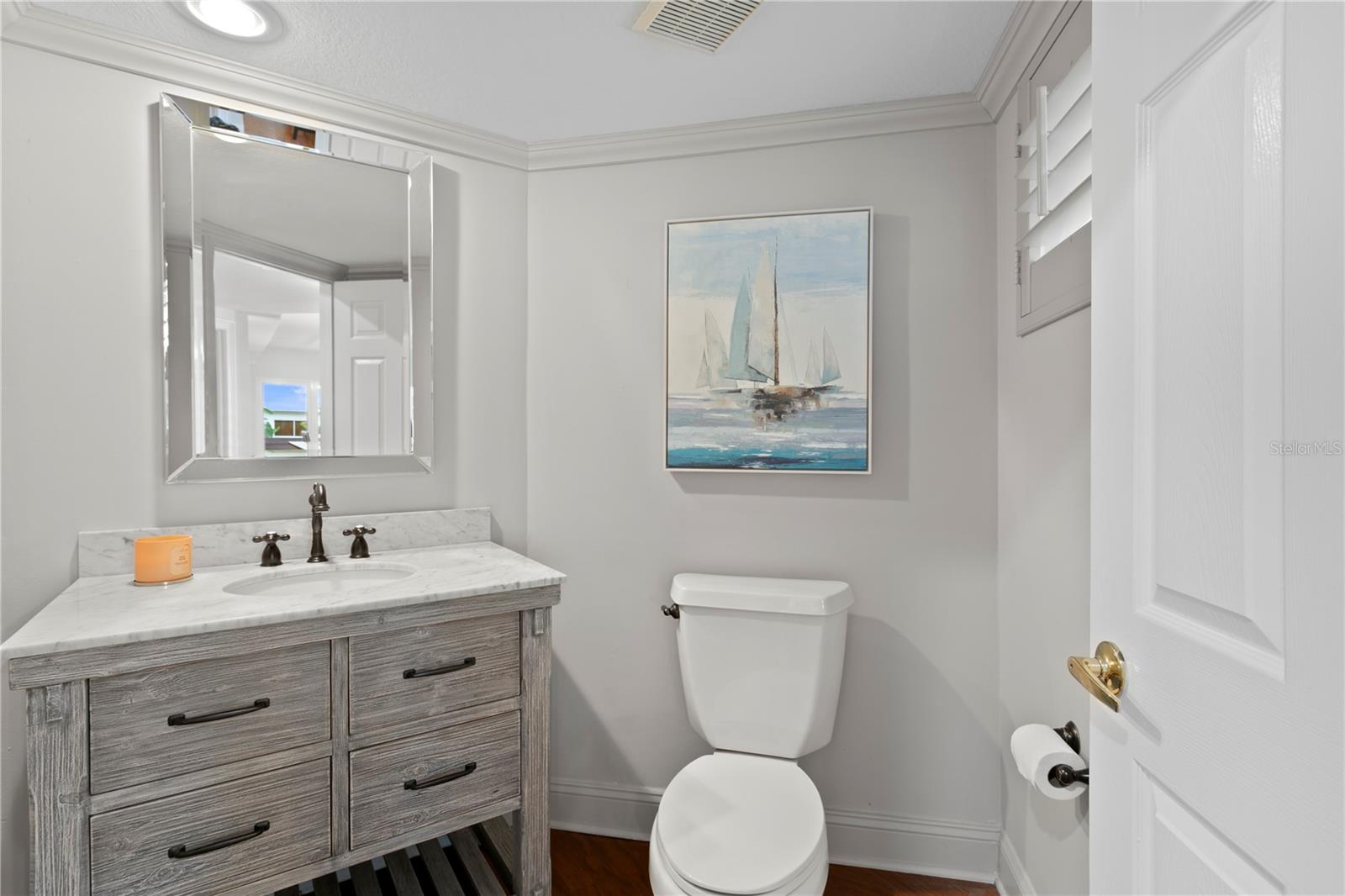 Sleek and updated powder bath with stylish finishes.