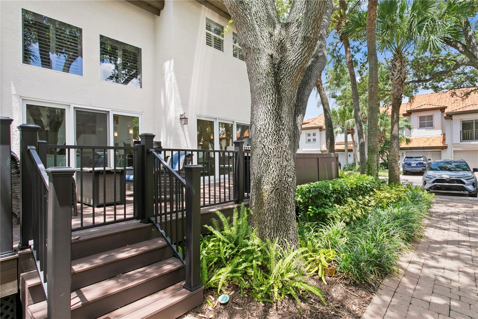 Two sets of sliding glass doors offer views of the courtyard and beautifully landscaped grounds.