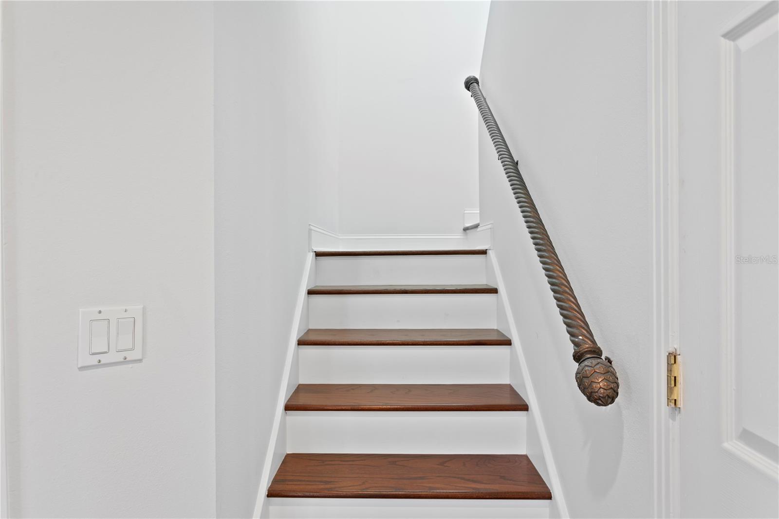 This stairway, accessible from the primary suite, leads to the rooftop deck.