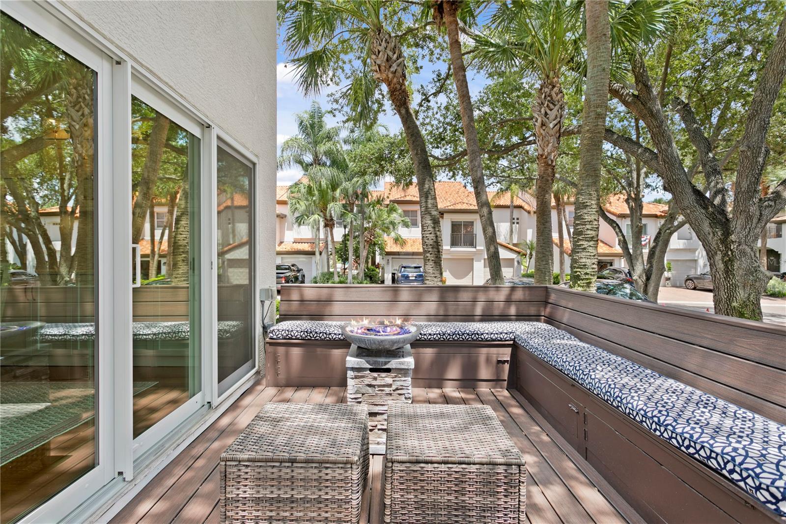 Built-in bench seating and plush cushions make backyard entertaining effortless.