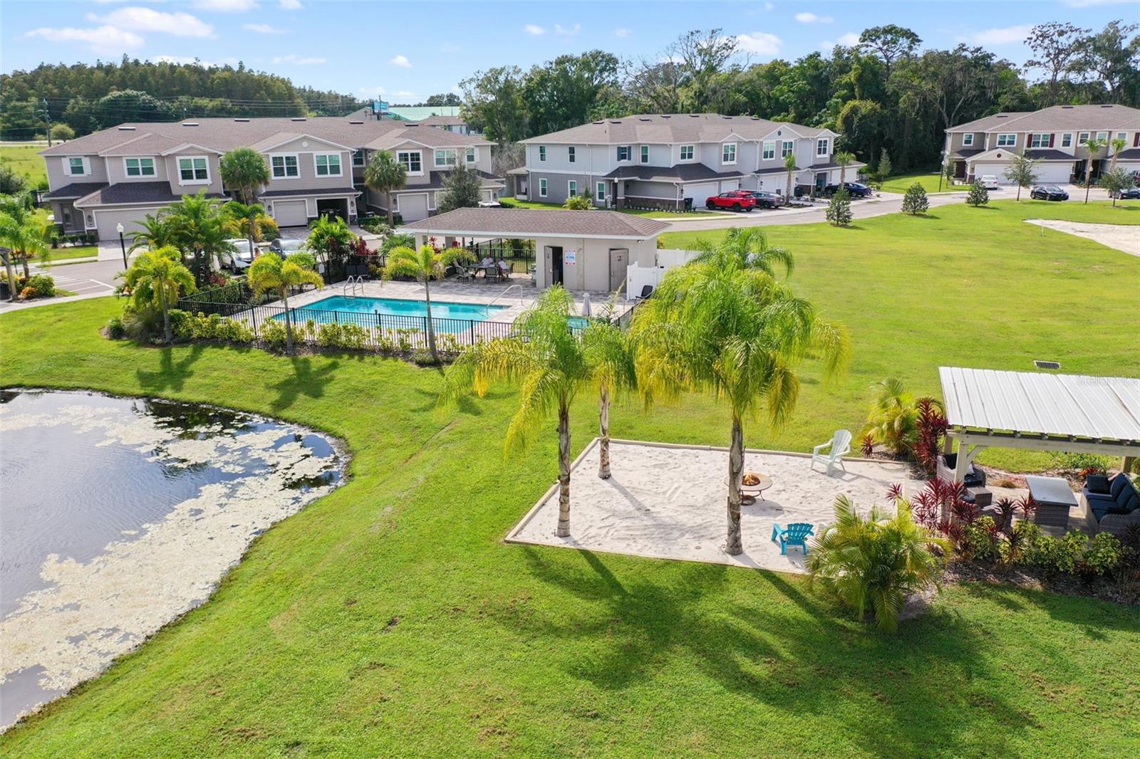 Pool with townhome in distance