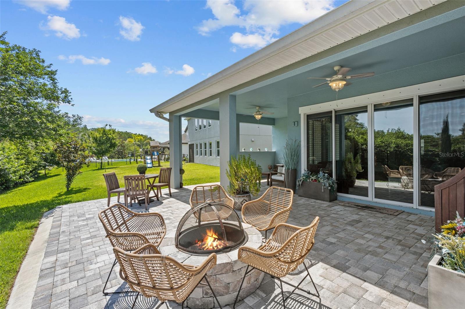 Outdoor extended pavered patio with built in fireplace