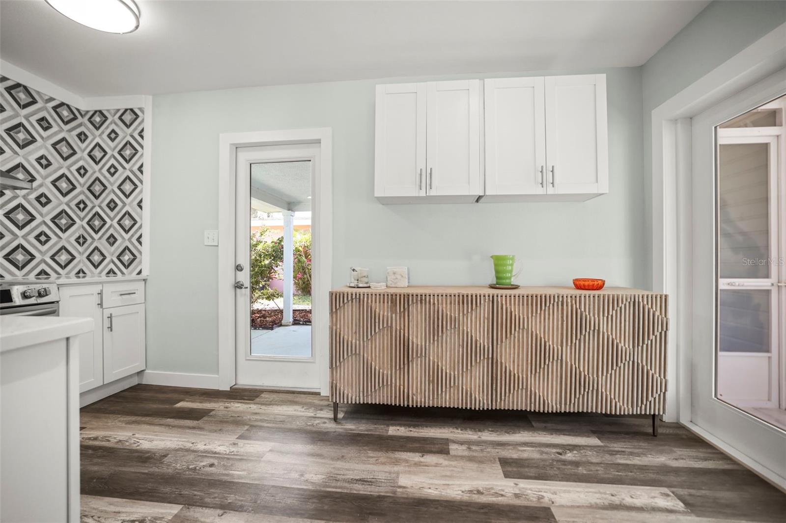 Kitchen with 2 glass doors updated cabinetry stainless and Quartz counters