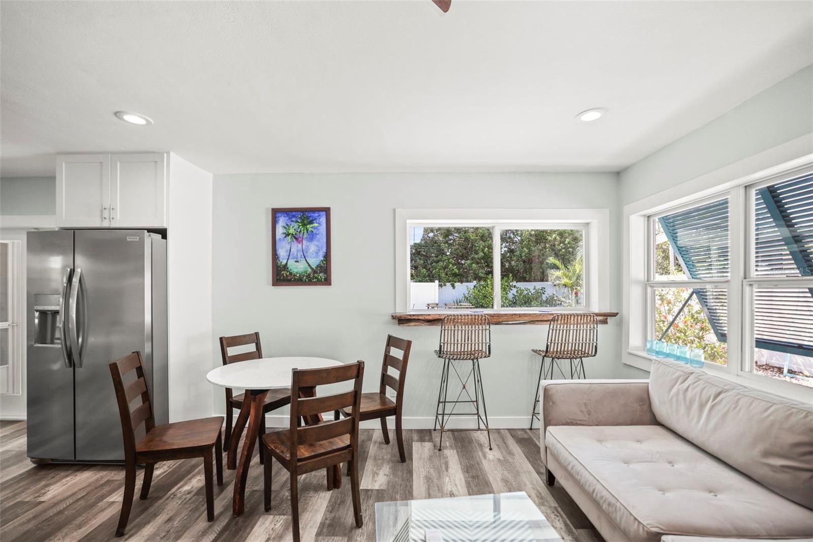 Living room with a fun pass-through window to the pool.