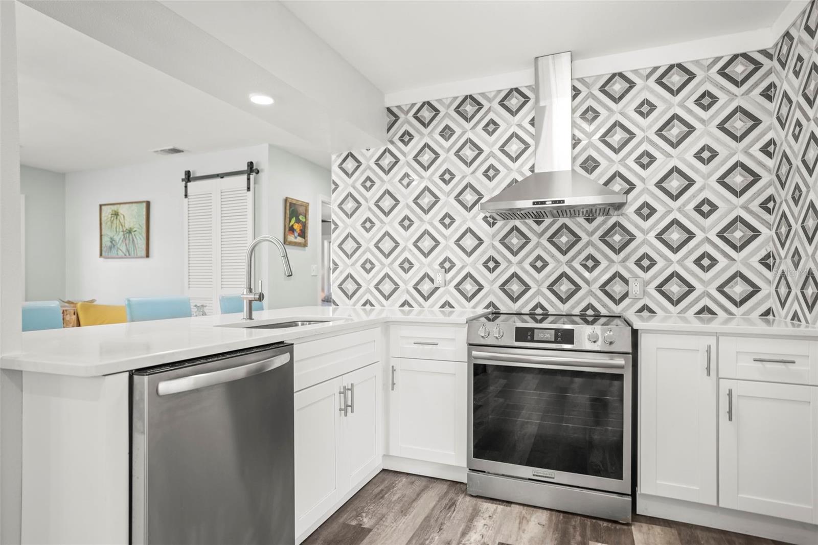 Updated kitchen open to living room with gorgeous backsplash and Quartz counters